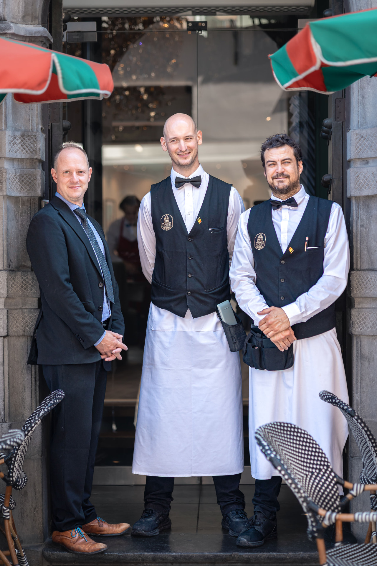 Le directeur et les serveurs de la Brasserie Auguste sur le seuil de la Grand-Place