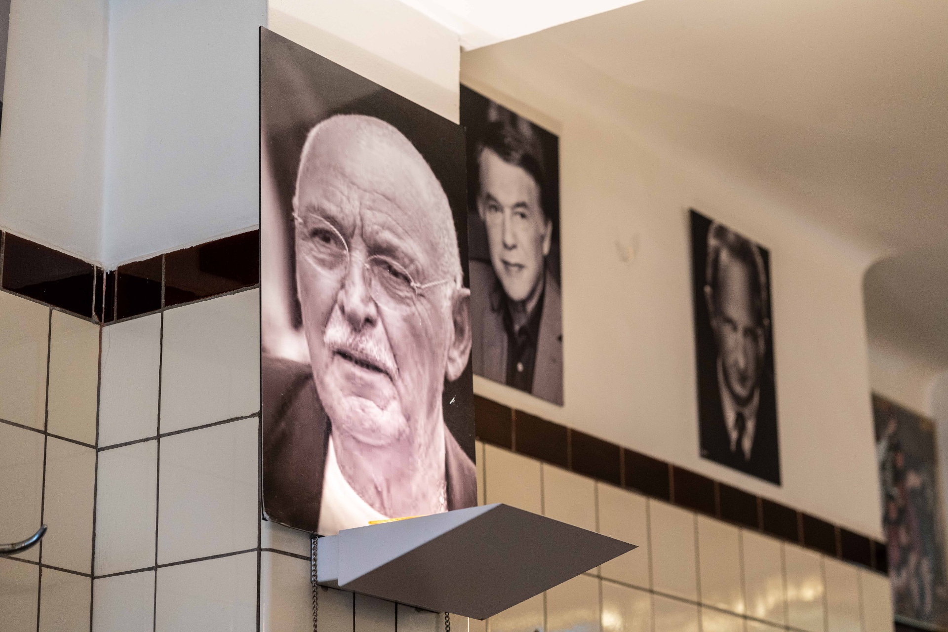 Mur de portraits noir et blanc d'habitués au Pré Salé