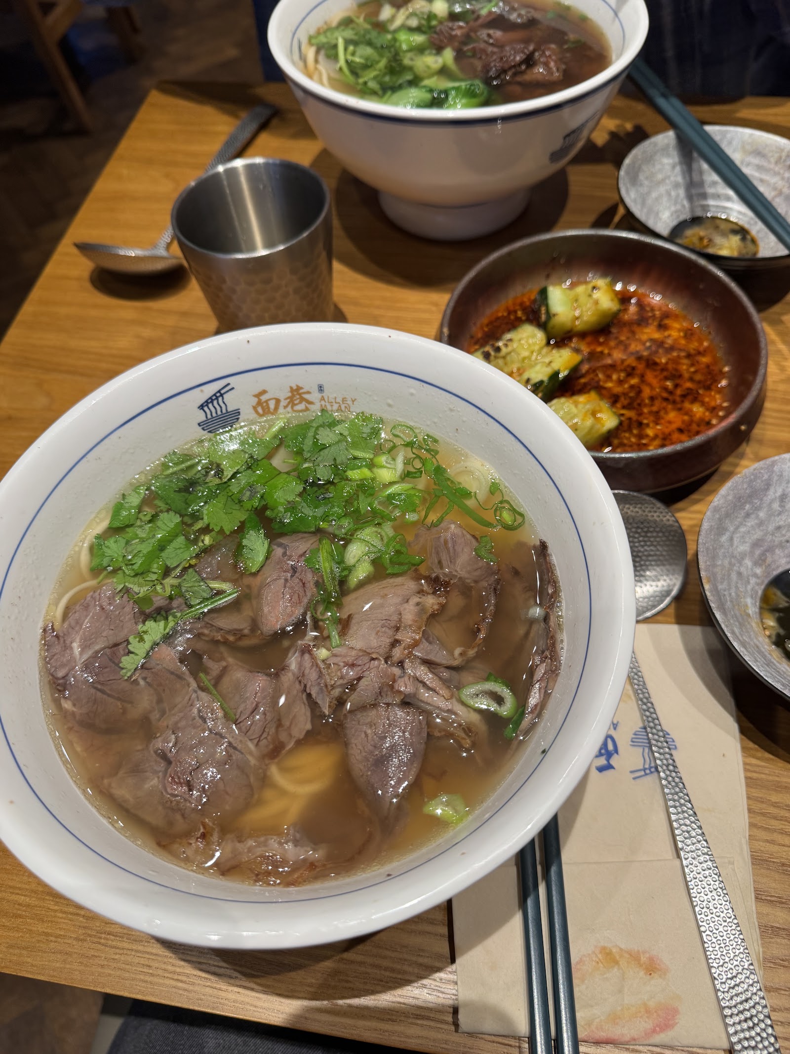 Bol de soupe de nouilles au bœuf et concombres pimentés chez Alley Mian