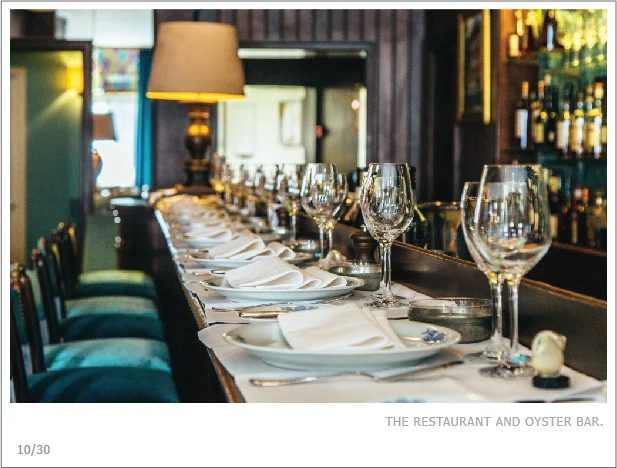 L'oyster bar de L'Écailler du Palais Royal, tables et lampes en enfilade